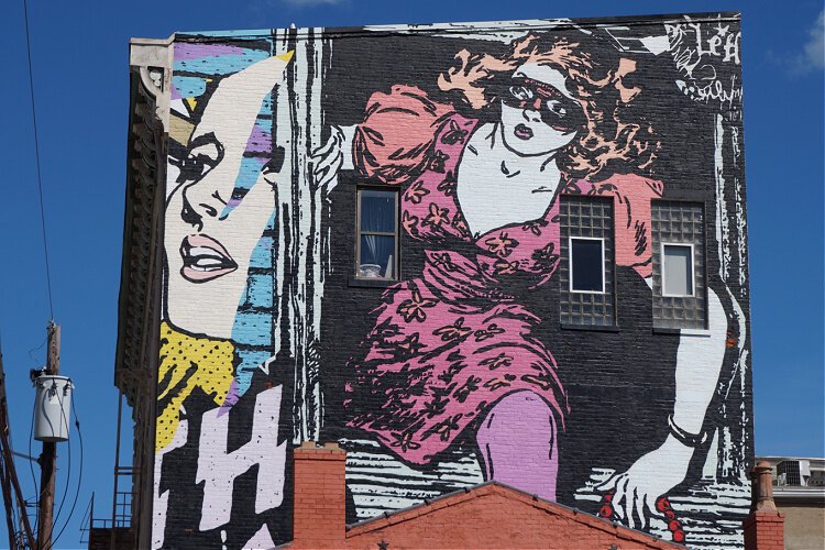 'Around the Corner' is a mural in Covington done by the Brooklyn street art duo Faile.