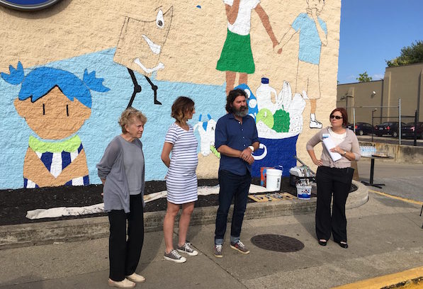 Left to right: Covington Mayor Sherry Carran, joins Lesley Amman and Jarrod Becker of BLDG, and Patty Leeseman of Kroger, at Thursday’s introduction of the mural.